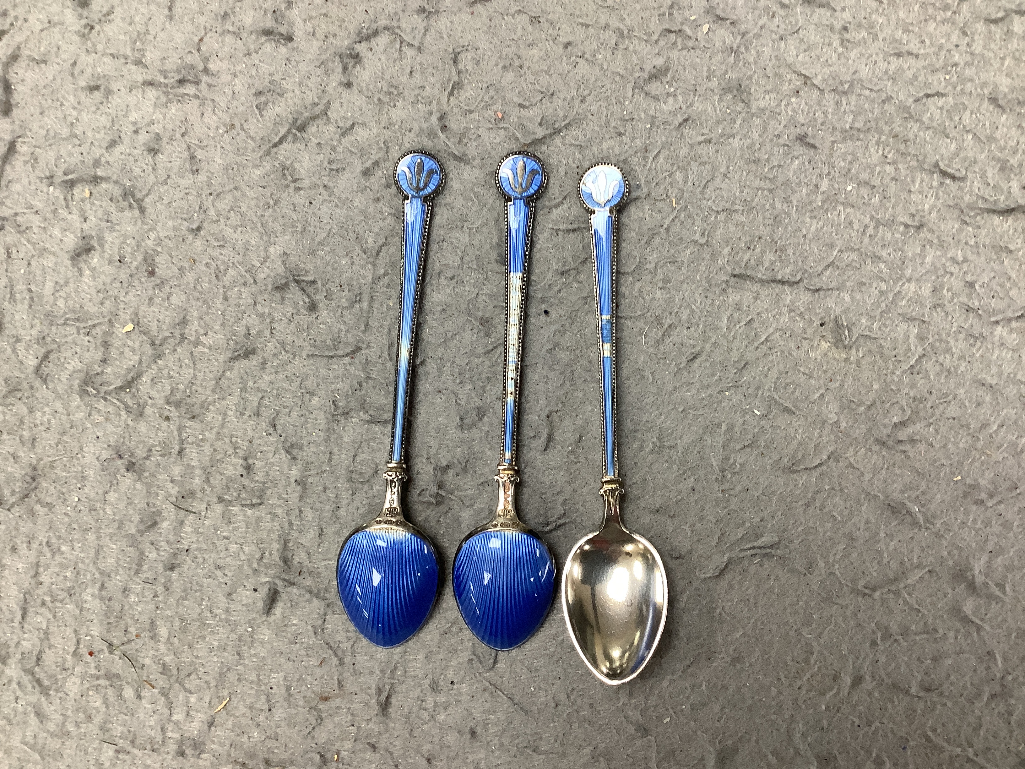 A cased Royal Worcester gilt and powder blue six piece coffee set with silver teaspoons, set of six silver and guilloche enamel teaspoons together with a Meissen blue and white ‘onion pattern’ serving dish, 39cm wide